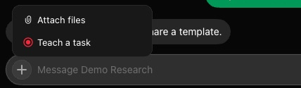 The plus button at the left of the message box, with its menu open above it: Attach files, and Teach a task with a red record icon